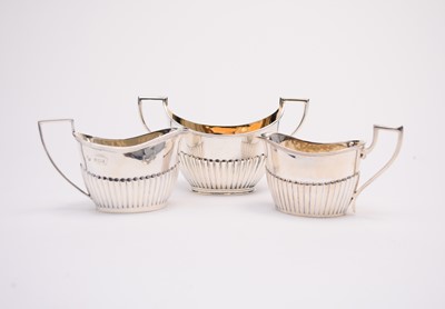Lot 15 - A two handled silver sugar bowl and two silver cream jugs