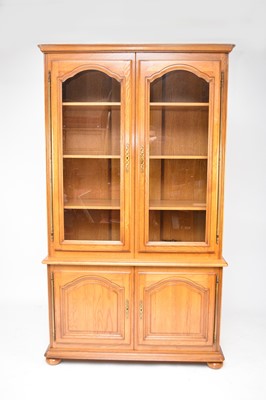 Lot 598 - A recent French light oak glazed display cabinet