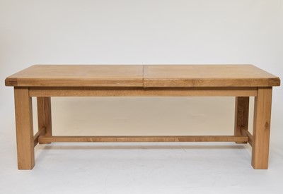 Lot 599 - A modern light oak extending dining table