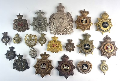 Lot 144 - A collection of twenty helmet plates and cap...