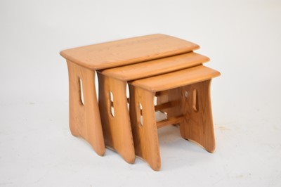 Lot 576 - An Ercol blond ash nest of three tables