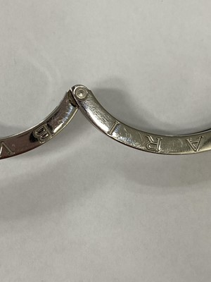 Lot 94 - A yellow metal and stainless steel Bvlgari hinged bangle