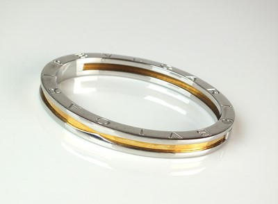 Lot 94 - A yellow metal and stainless steel Bvlgari hinged bangle