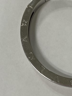 Lot 94 - A yellow metal and stainless steel Bvlgari hinged bangle