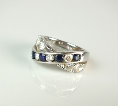 Lot 59 - A diamond and sapphire crossover ring