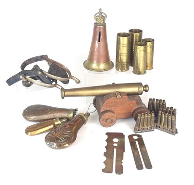 Lot 204 - Militaria including powder flasks, trench art, signal cannon etc