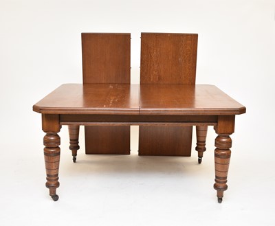 Lot 554 - An Edwardian oak wind-out extending dining table