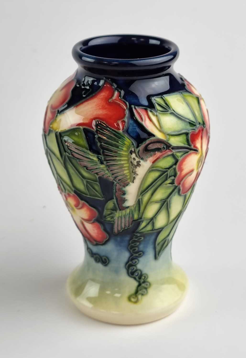 Lot A small Moorcroft vase in the Hummingbird pattern designed by Anji Davenport