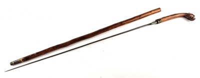Lot Victorian sword cane with a handle carved as a dog with red glass eyes