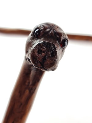 Lot Victorian sword cane with a handle carved as a dog with red glass eyes