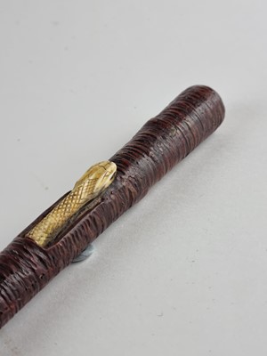 Lot An unusual Indian sword cane, circa 1900, decorated with a snake