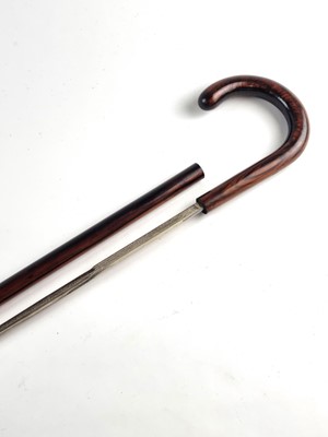 Lot A late 19th/early 20th-century hardwood sword cane with Toledo blade