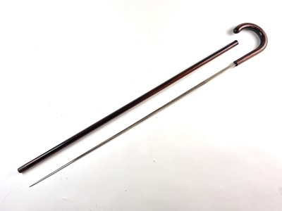 Lot A late 19th/early 20th-century hardwood sword cane with Toledo blade