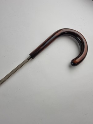 Lot A late 19th/early 20th-century hardwood sword cane with Toledo blade