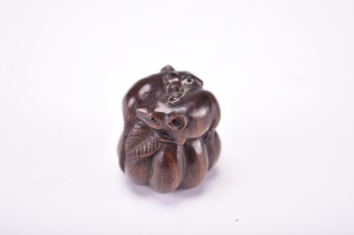 Lot 112 - A Japanese carved wood netsuke of rats on a gourd