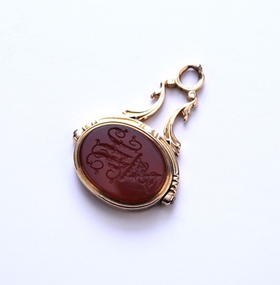 Lot 80 - A yellow metal carnelian intaglio swivel fob