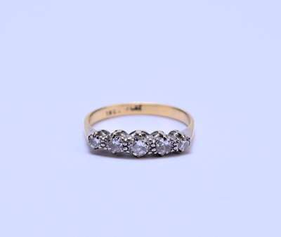 Lot 63 - A yellow metal graduated five stone diamond ring