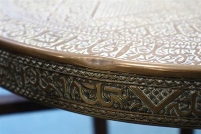 Lot 301 - An early 20th century central Asian brass topped occasional table