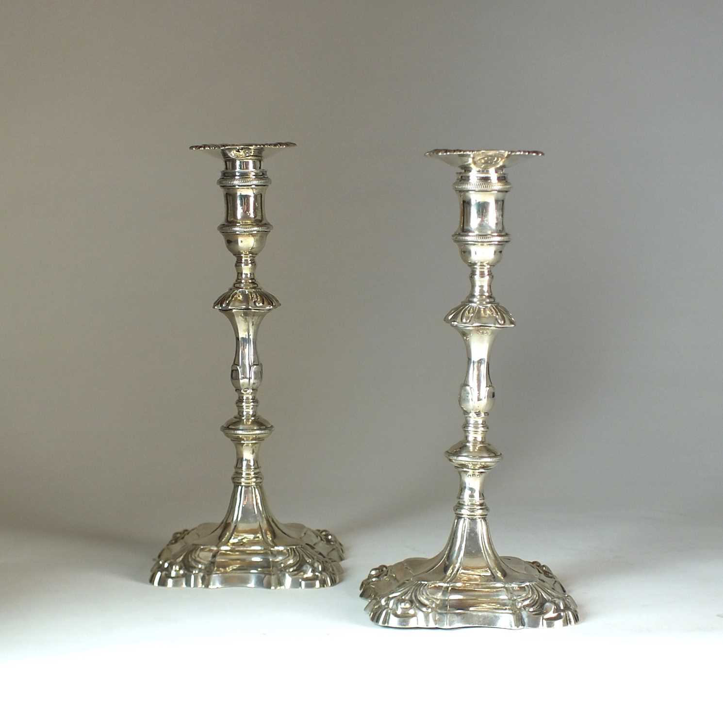 Lot 20 - A pair of George II cast silver candlesticks