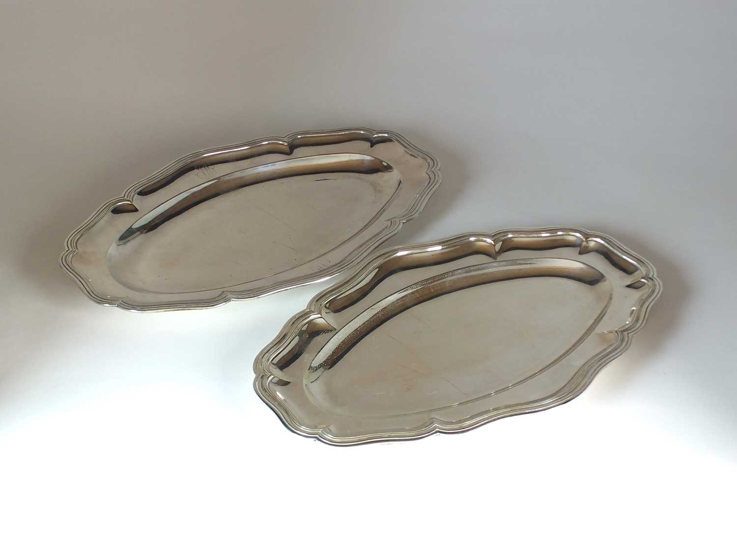 Lot 28 - A French silver serving plate and a silver plated example