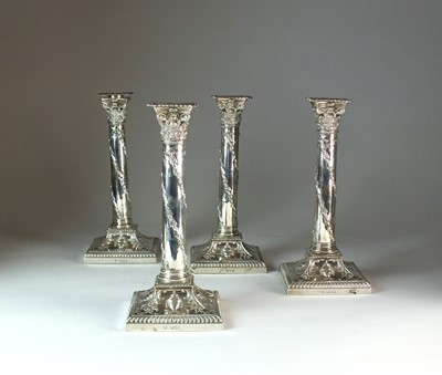 Lot 18 - A set of four Victorian silver mounted candlesticks