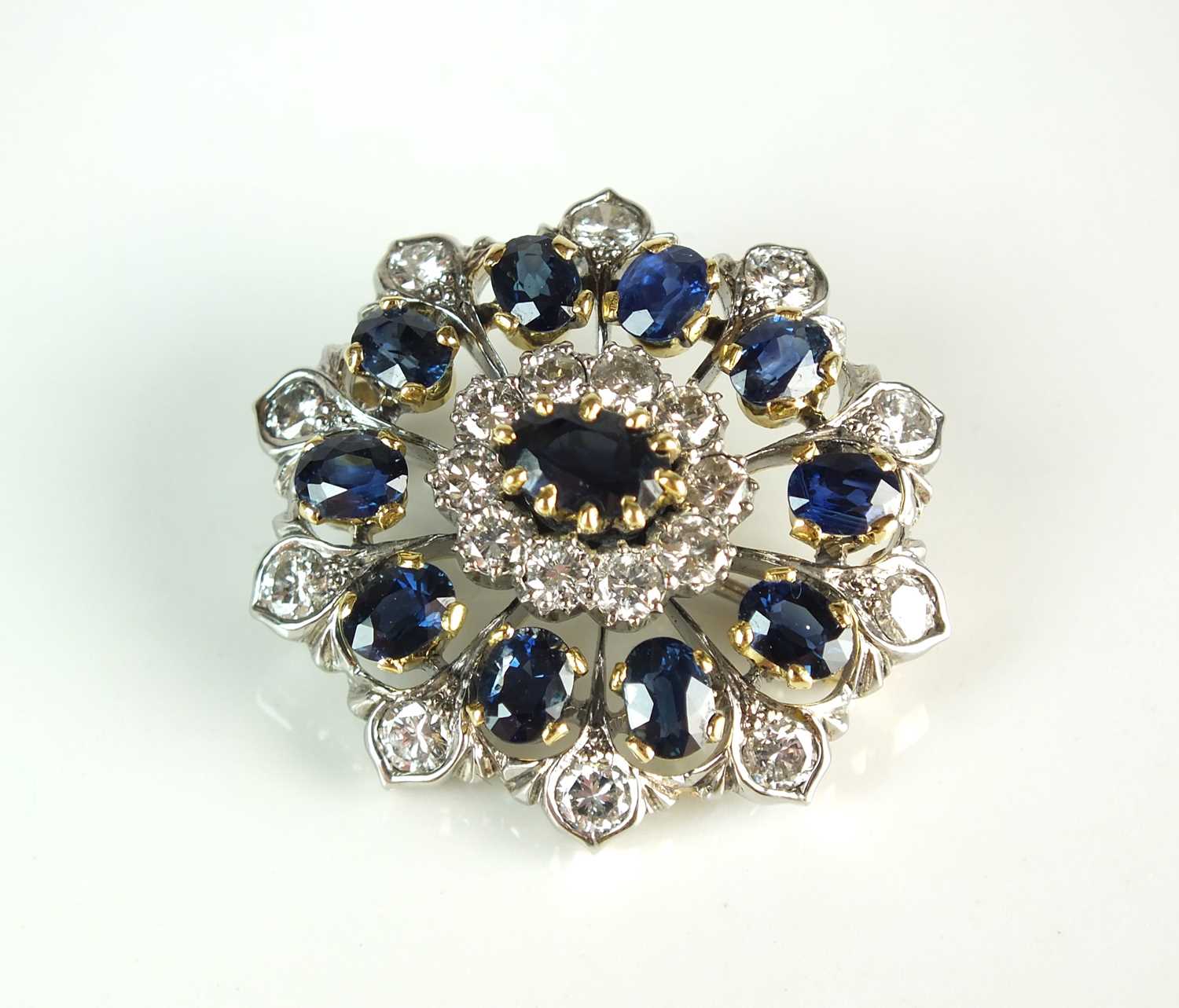 Lot 56 - A sapphire and diamond oval cluster brooch