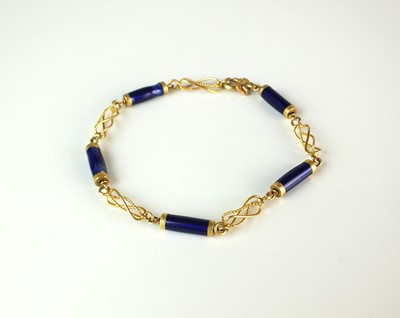 Lot 65 - A yellow metal and blue enamel bracelet