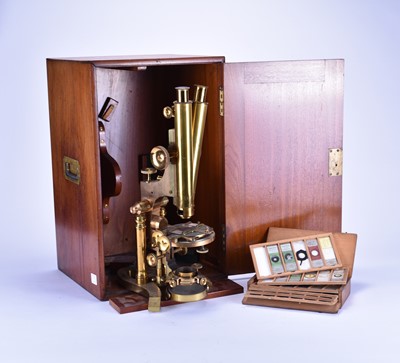 Lot 318 - A 19th century brass binocular microscope by Ross, with lenses and a box of slides (qty)