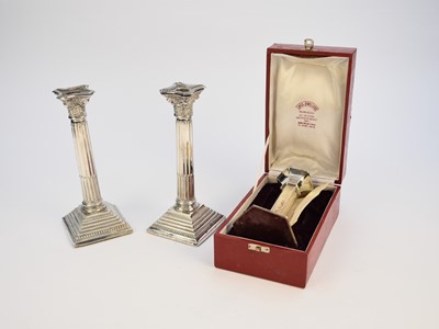 Lot 41 - A pair of silver mounted candlesticks and a white metal candlestick