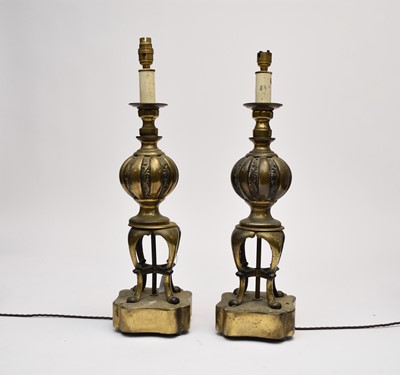 Lot 426 - A pair of antiqued brass table lamps