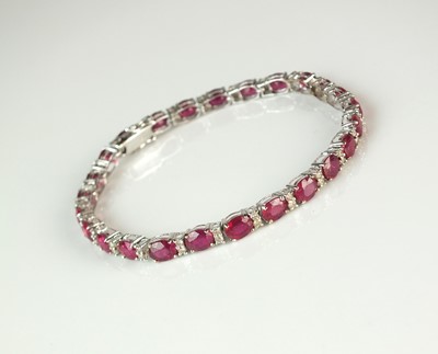 Lot 70 - An 18ct white gold ruby and diamond line bracelet