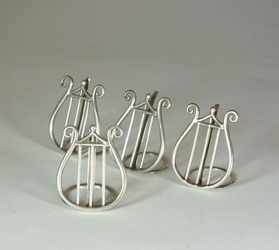 Lot 24 - A set of four silver menu holders