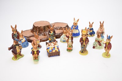 Lot 231 - Fifteen Royal Doulton Bunnykins figures and a Beswick display stand