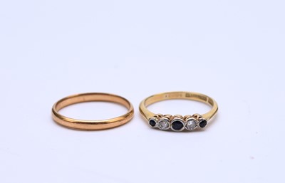 Lot 75 - A 22ct gold band and a sapphire and diamond ring