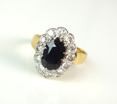 Lot 81 - An 18ct gold sapphire and diamond oval cluster ring
