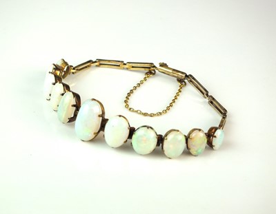 Lot 95 - A yellow metal graduated opal bracelet