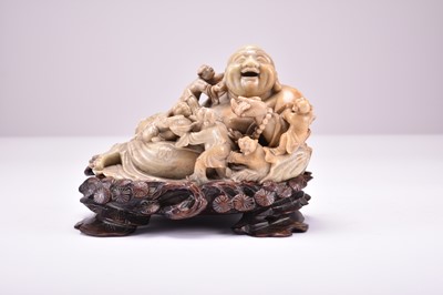 Lot 579 - A Chinese carved soapstone figure of a laughing Buddha