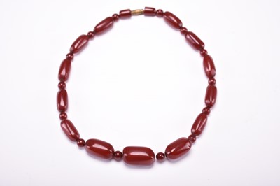 Lot 580 - A cherry amber beads necklace, early 20th century