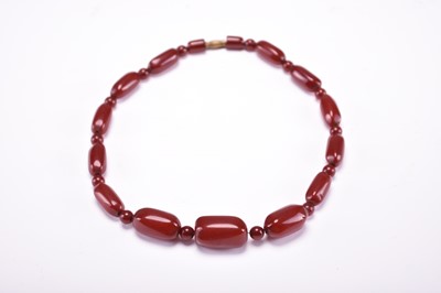 Lot 580 - A cherry amber beads necklace, early 20th century