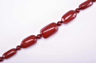 Lot 580 - A cherry amber beads necklace, early 20th century