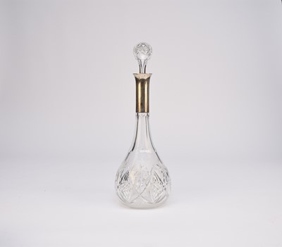 Lot 1 - A white metal mounted cut glass decanter