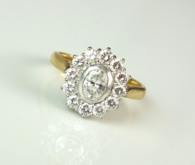 Lot 88 - An 18ct gold oval diamond cluster ring