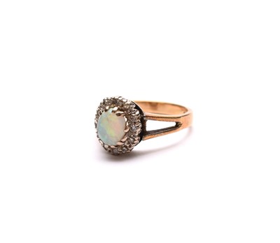 Lot 62 - An oval opal and diamond cluster ring