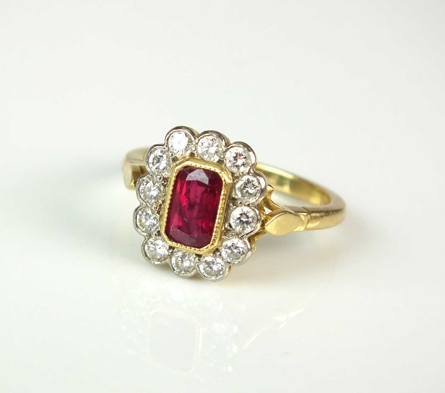 Lot 46 - An 18ct gold ruby and diamond cluster ring