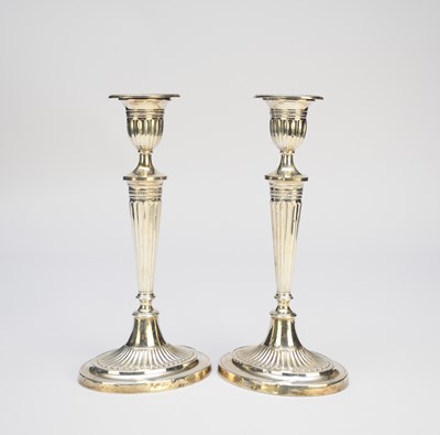 Lot 4 - A pair of early 20th century silver mounted candlesticks