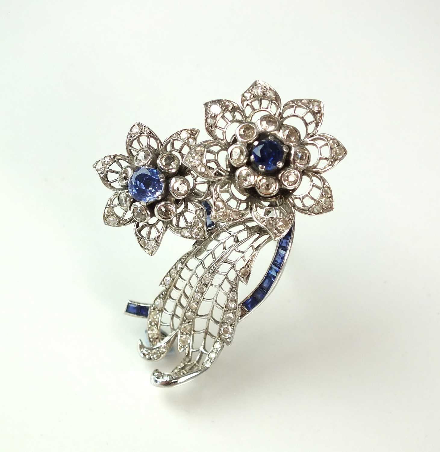 Lot 55 - A sapphire and diamond floral spray brooch