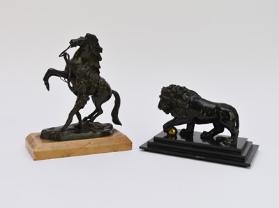 Lot 503 - A bronze model of a lion and a bronze Marley horse