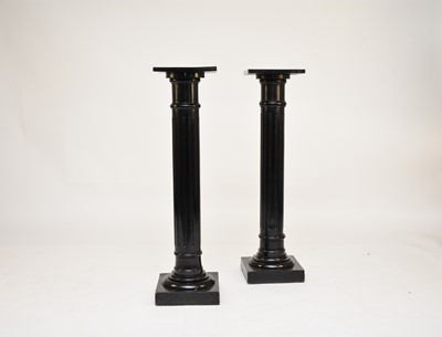 Lot 560 - A pair of late Victorian ebonised wood torchere stands