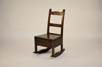 Lot 551 - An early 19th century oak box rocking chair