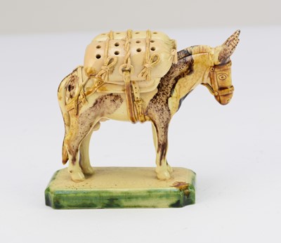 Lot 264 - A Continental creamware model of a donkey, 19th century